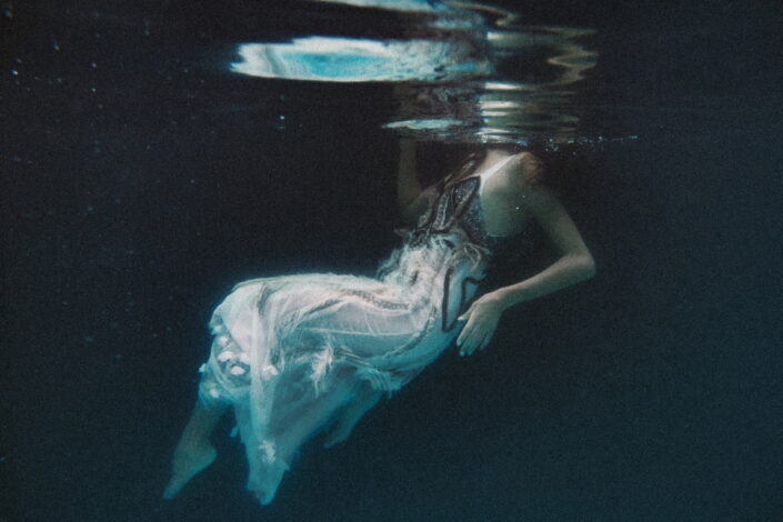 Woman in dress, underwater